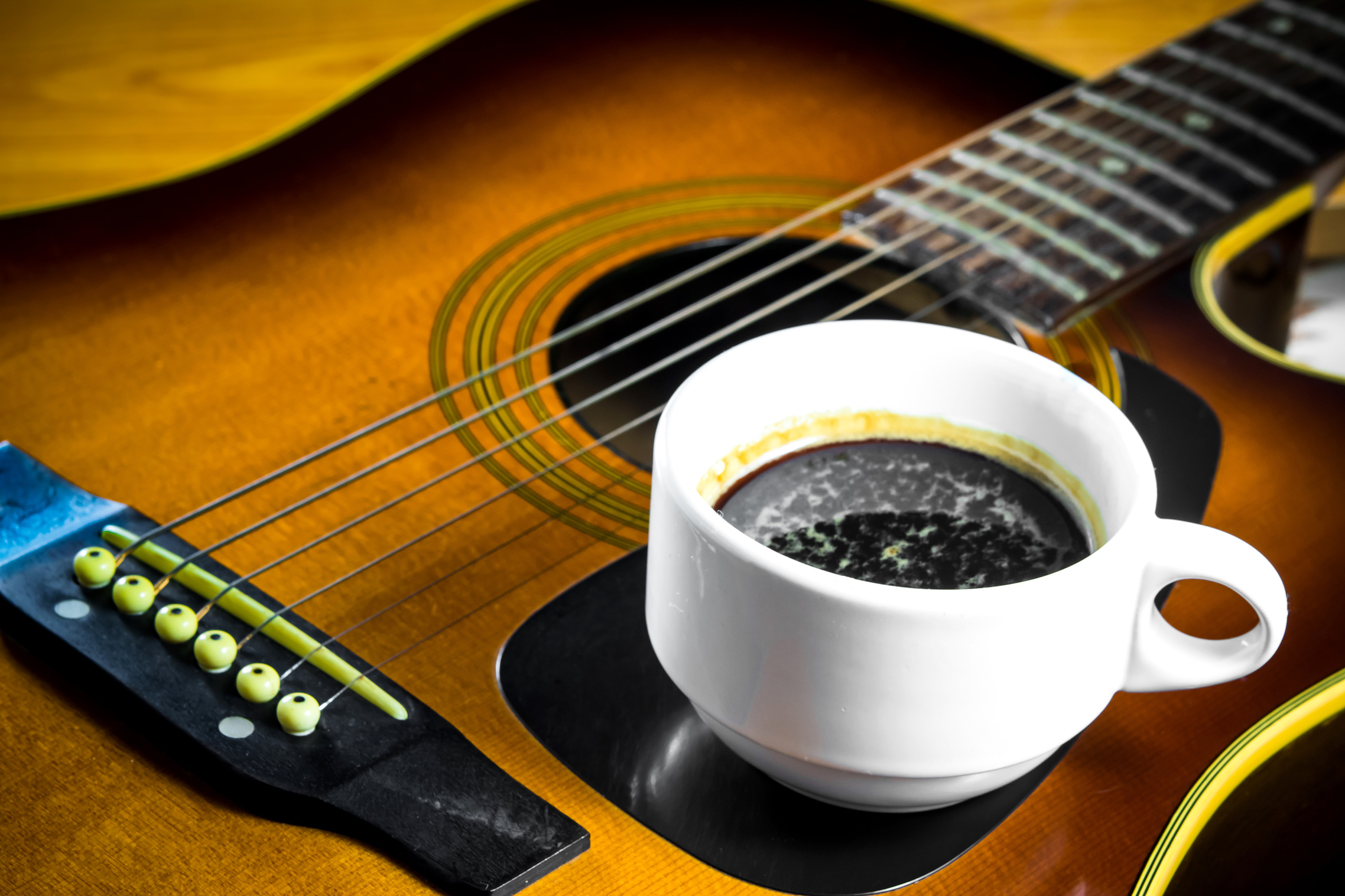 Acoustic guitar with coffee